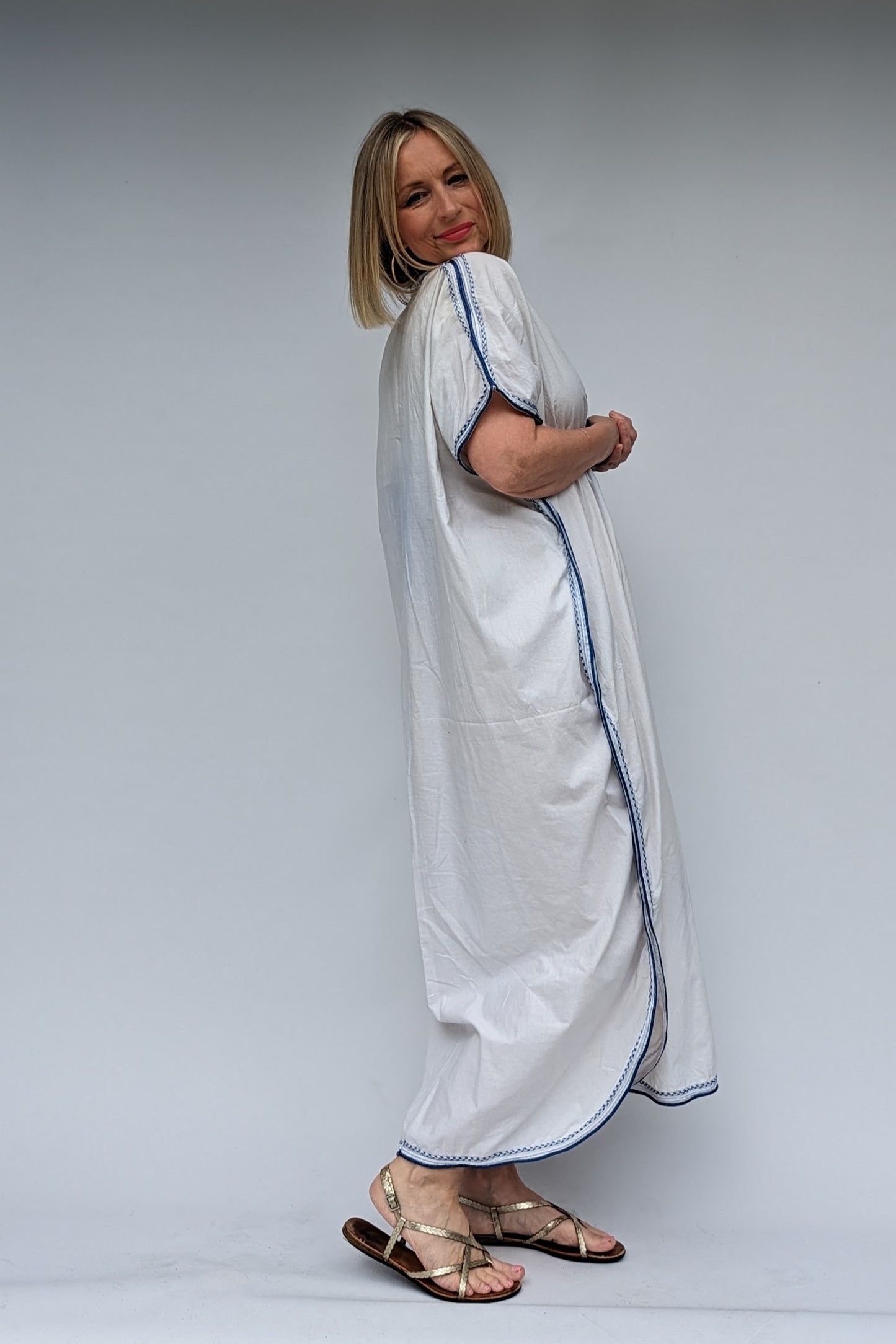 side of long blue and white kaftan dress