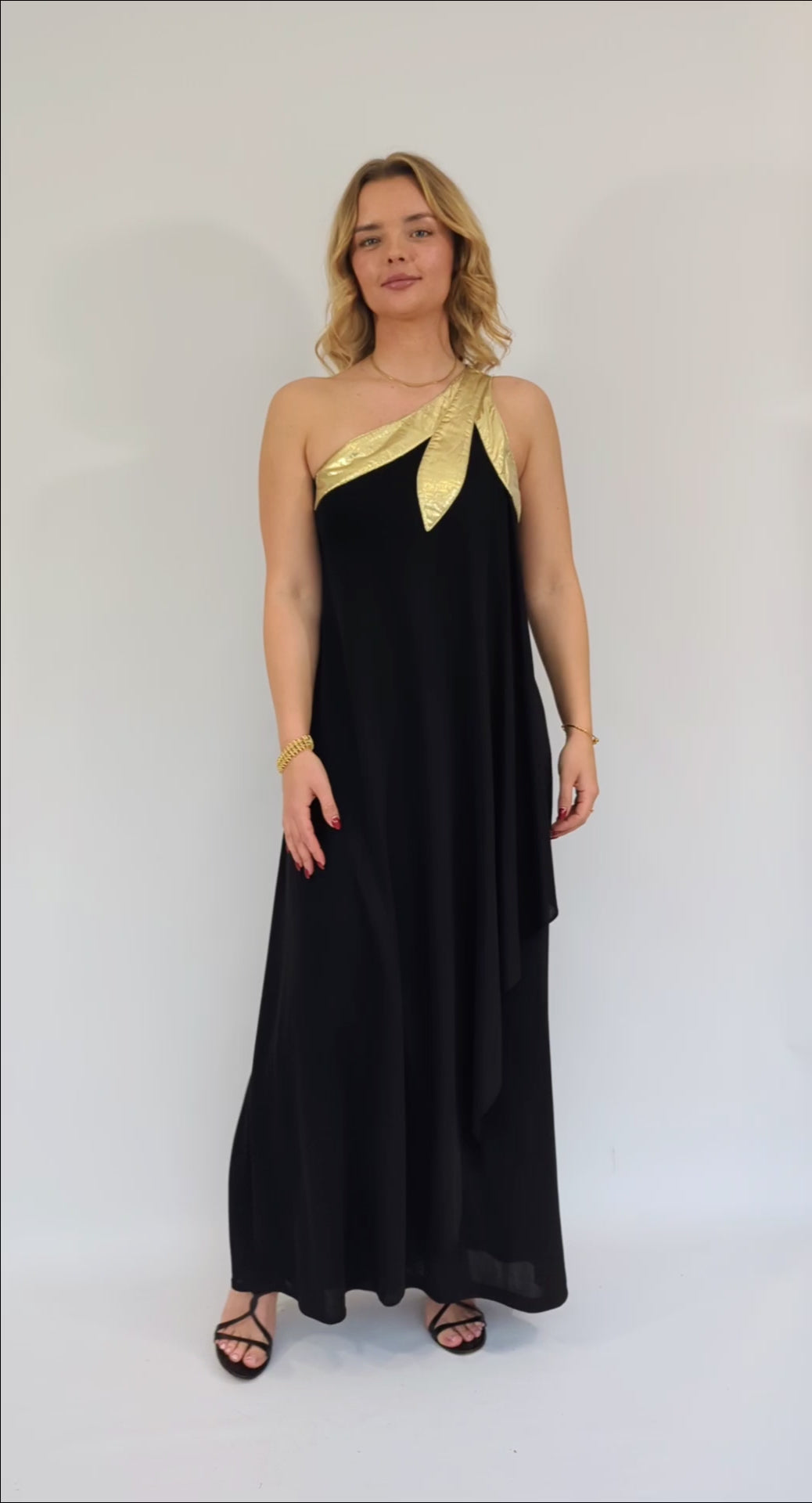 video of gold lame asymmetric black maxi dress