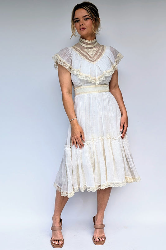 victorian style lace vintage dress in cream from 1970s with a lace butterfly on the neckline and cape style top